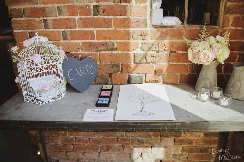 Wedding-cards-table-withfingerprint-guest-book-jugs-of-flowers