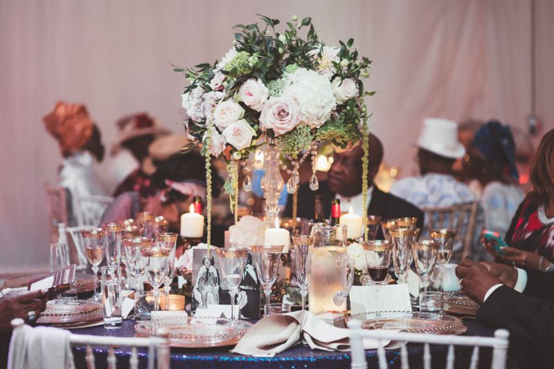 Elegant tall wedding centrepiece crystal candle stick nude pink white green flowers trailing with candles and navy sequin table cloth Iscoyd Park