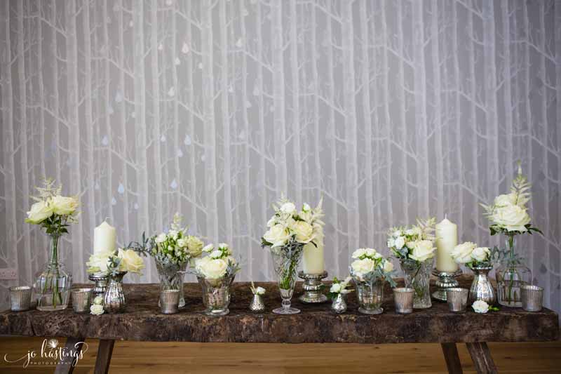 Elegant wedding ceremony table styling crystal vases mercury silver vases cream flowers