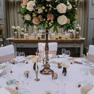 Tall bronze centrepieces wedding flowers at Hampton Manor by Passion for Flowers - peach cream foliage (1)