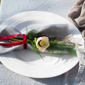 Wedding place settings flowers with deep pink ribbon