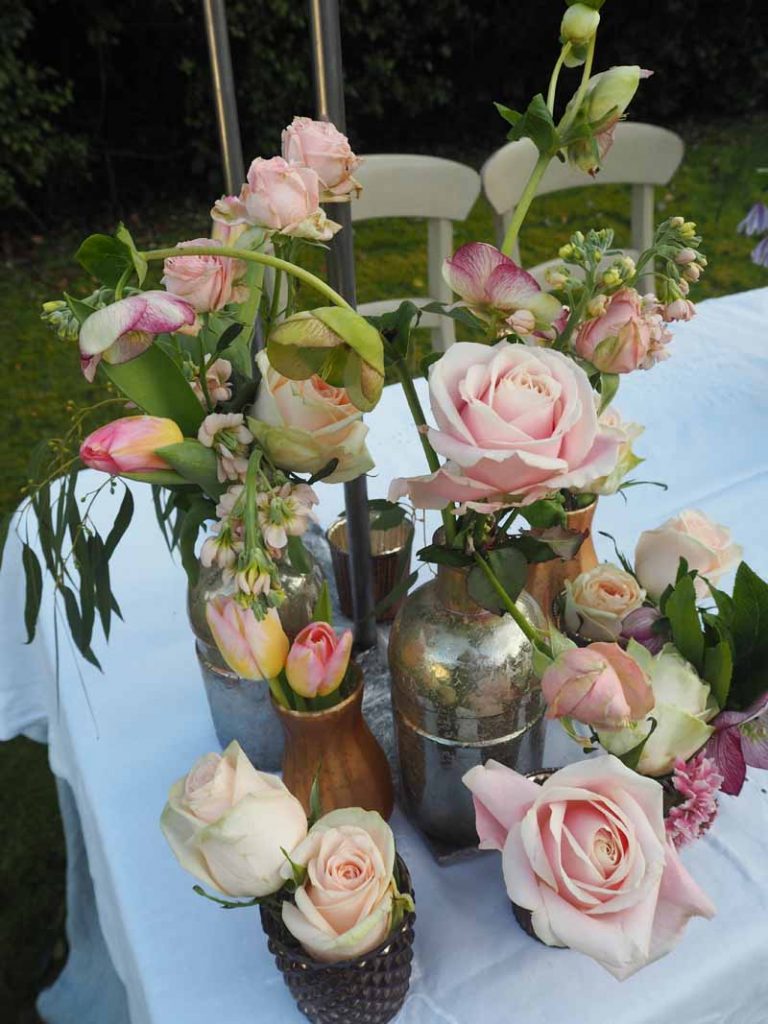 Wedding Flowers grouping of bronze copper gold bottles with rose for centrepieces