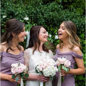 Elegant wedding flowers with lilac purple bridesmaids dresses Jenny Yoo