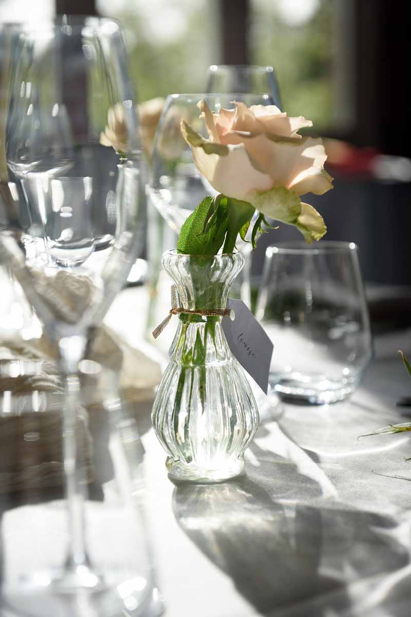 Nude roses in small posy vases autumn wedding centrepieces