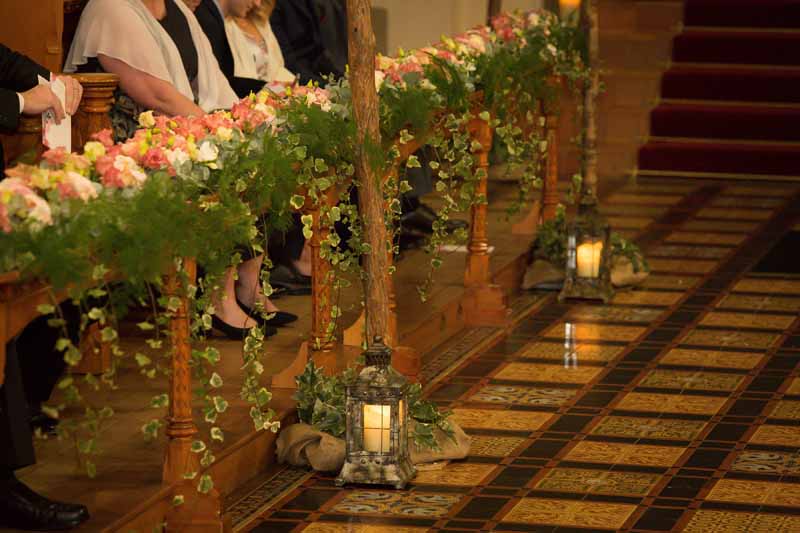 Epic wedding ceremony flowers pink peach flowers the length of the church Passion for Flowers at Stanbrook Abbey
