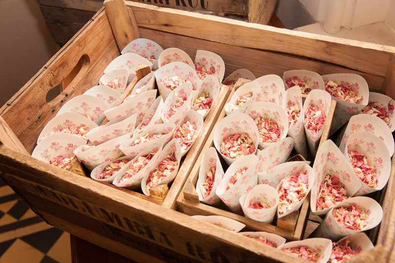Pink confetti in cones in wooden crates