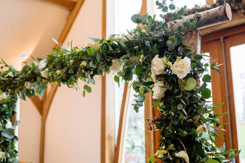 Birch-Arch-with-foliage-and-white-flowers-rustic-wedding-ceremony