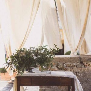 Outdoor wedding ceremony table floral display rustic glamour Tuscany