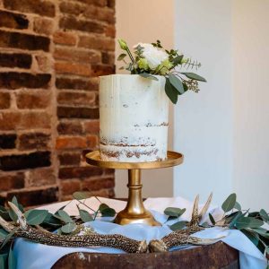 simple-white-and-gold-wedding-cake-with-foliage-to-top