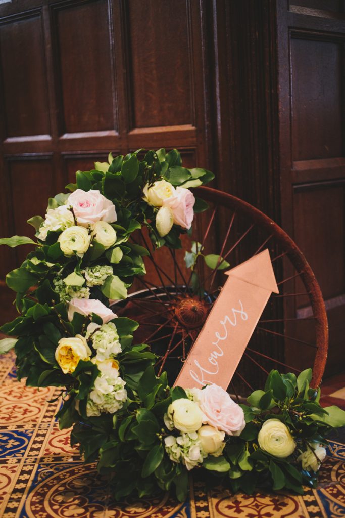 Alternative wreath floral garland on cart wagon wheel Hampton Manor Wedding Florist Passion for Flowers