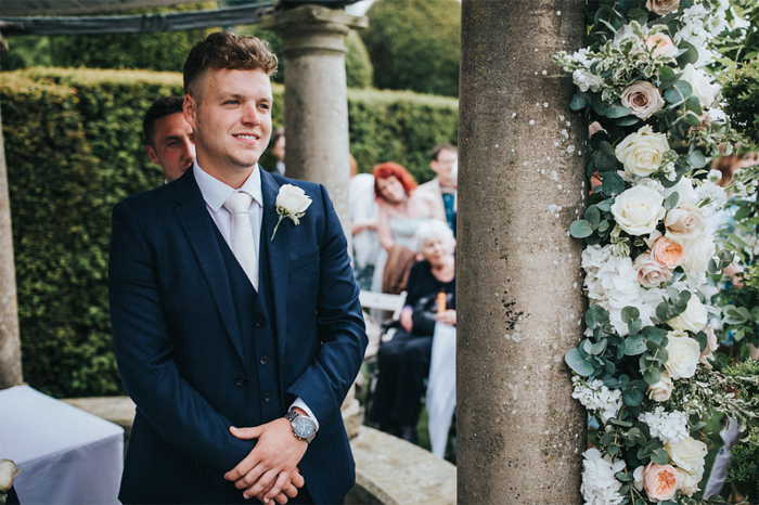 Birtsmorton Court outdoor wedding ceremony groom Arch of flowers