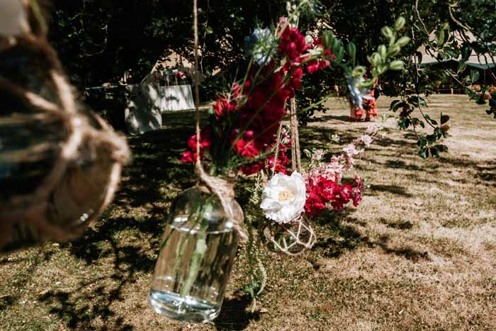 Hanging macrame bottle jars tipi wedding festival theme - florist Passion for Flowers