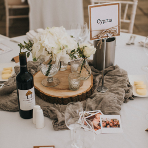 Rustic elegant centrepieces tree slices with gass vases and grey runner Birtsmorton Court Marquee wedding