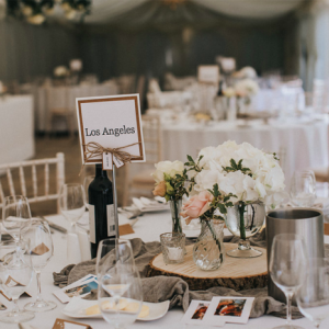 Rustic elegant centrepieces tree stumps with gass vases and grey runner Birtsmorton Court Marquee wedding