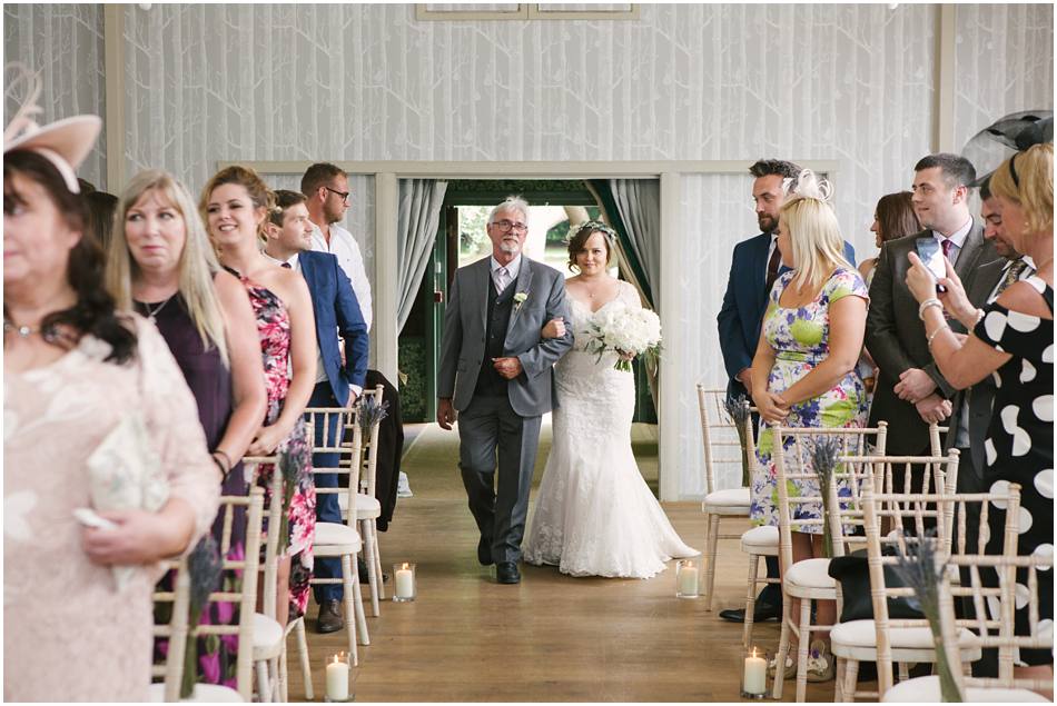 Hampton Manor wedding ceremony entrance of bride glass cylinder vases aisle decorations