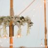 hanging flowers in marquee around poles