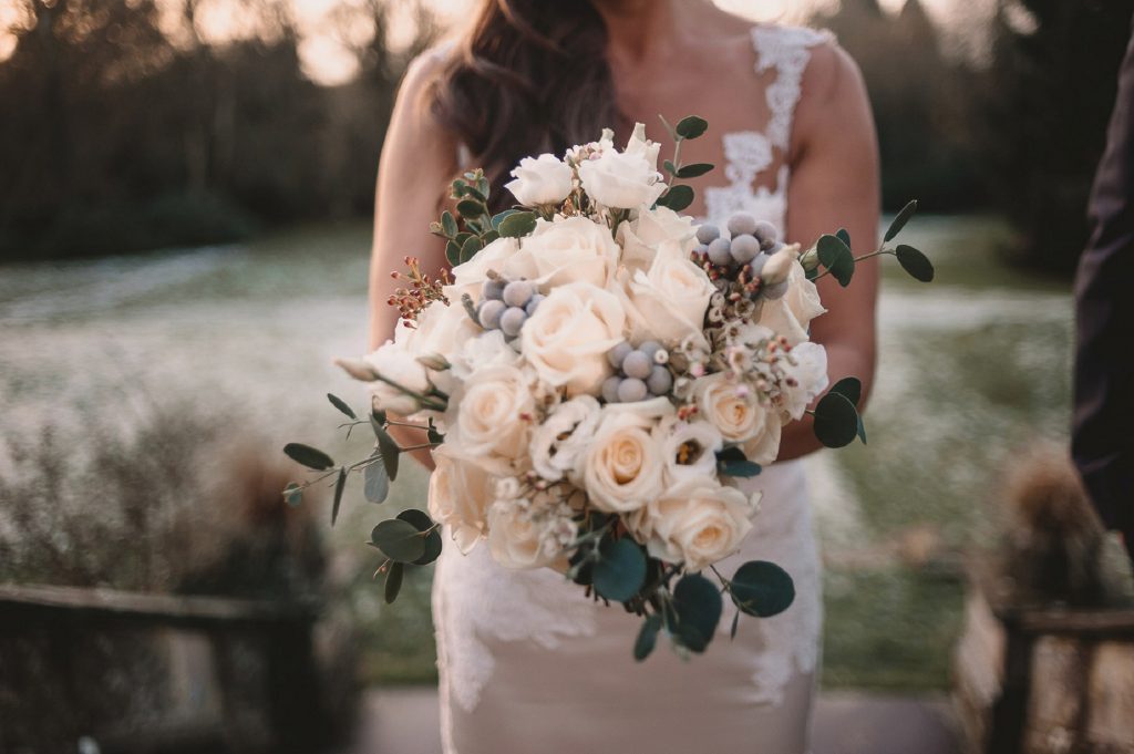 stunning winter wedding bouquet grey cream green roses foliage