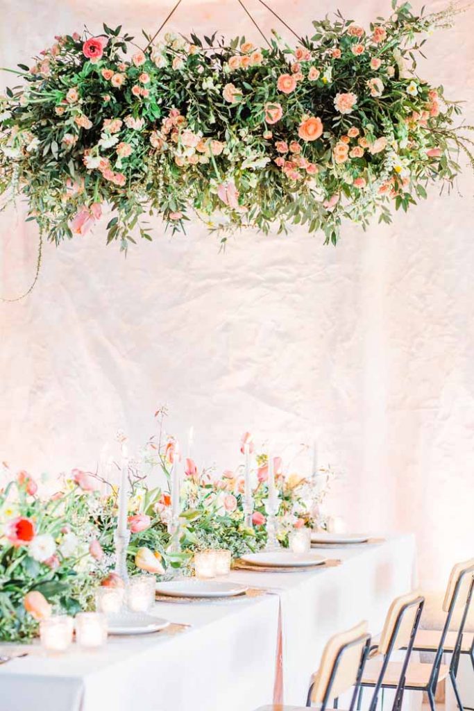 Hanging ring of flowers above wedding guest tables Passion for Flowers no foam