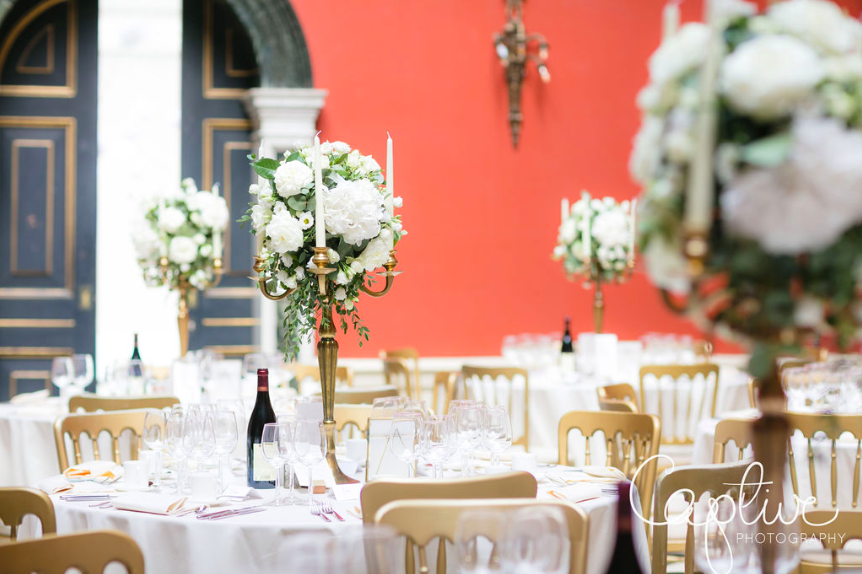 Tall wedding centrepieces candelabra white roses foliage