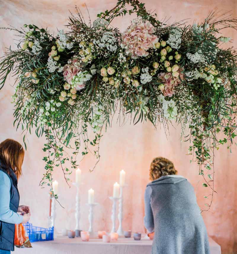 a cascade of flower petals on wire or fishing line  Hanging flowers,  Wedding day inspiration, Floral chandelier